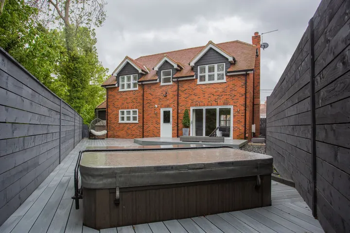 Brick house with a backyard jacuzzi