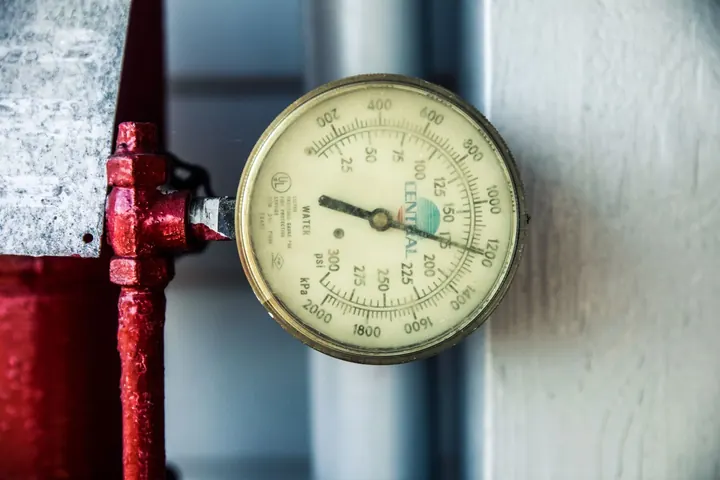 Pressure gauge on a water line reading PSI