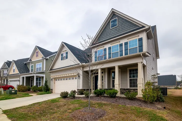 Row of suburban homes with garages and lawns