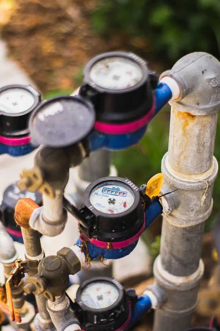 Row of water meters connected to supply pipes