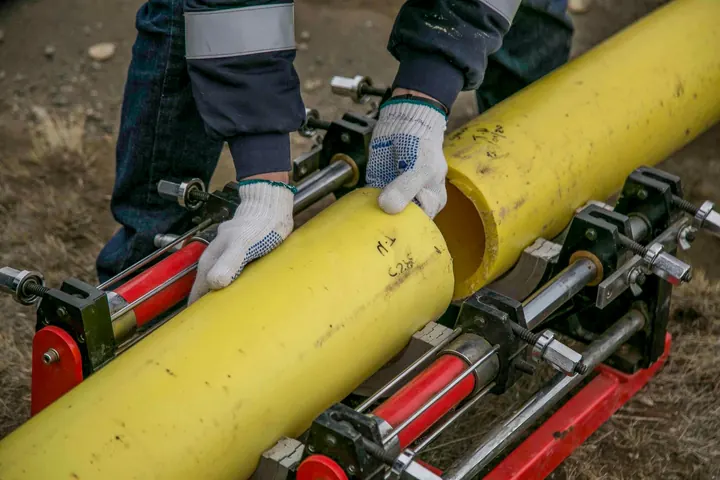 Worker laying pipe outdoors